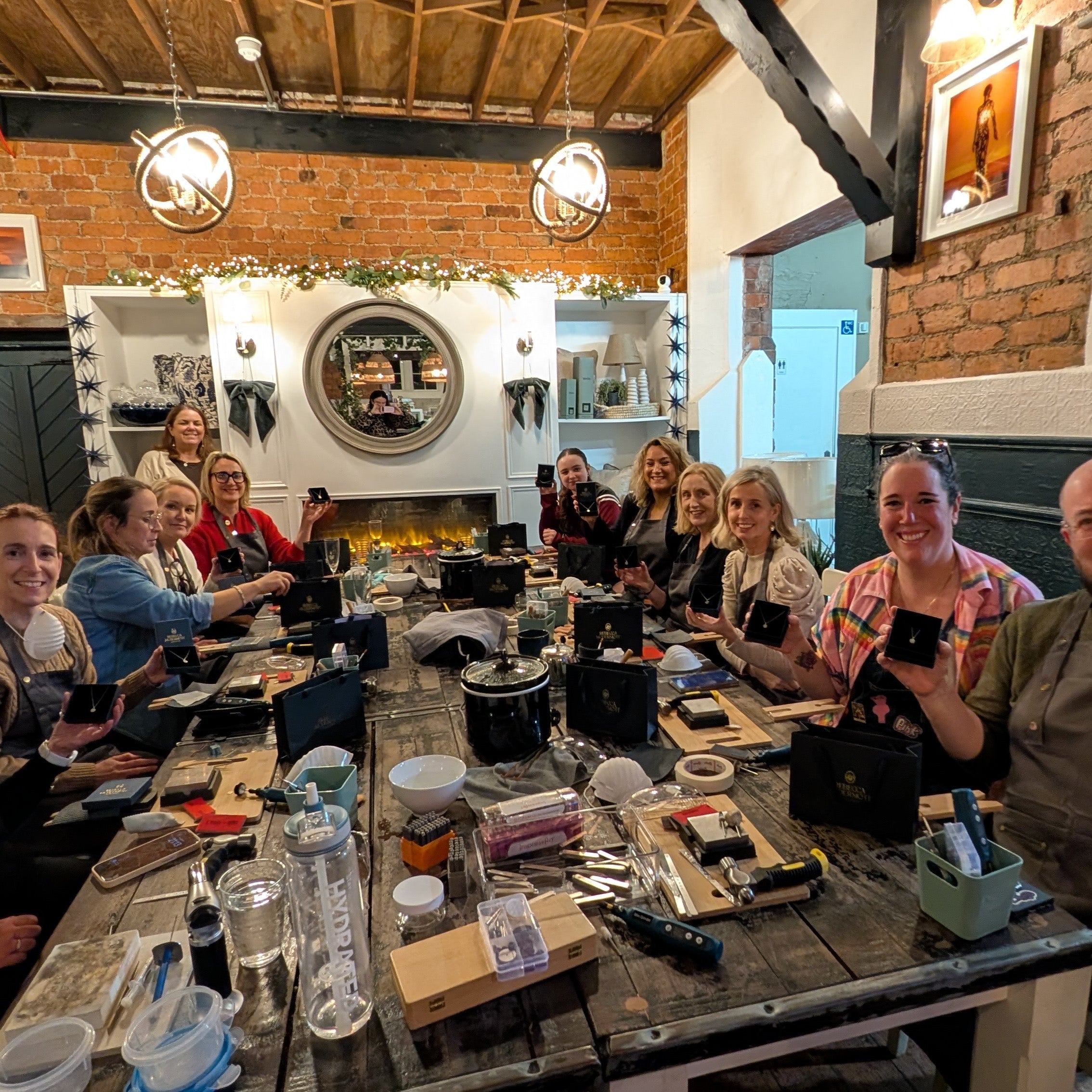 Group picture of silver pendant making jewellery workshop holding silver pendants made